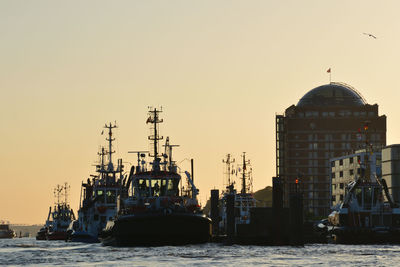 Ship in sea against sky during sunset