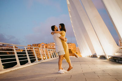 Romantic couple standing on bridge