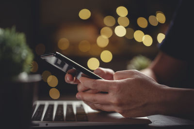 Midsection of man using mobile phone