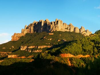 Scenic view of mountains against clear blue sky