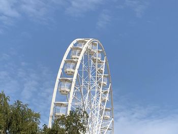 Low angle view of ferris wheel against blue sky