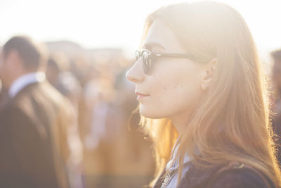 Headshot of young woman in sunlight