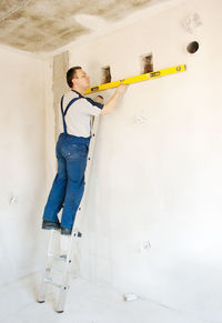 Side view of plumber working at home