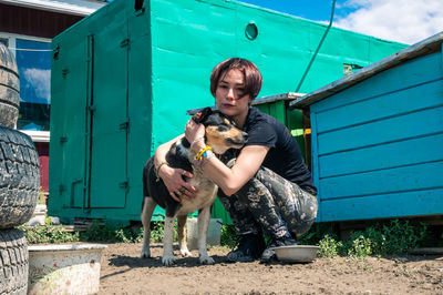 Dog at the shelter. animal shelter volunteer takes care of dogs. lonely dogs in cage with volunteer.