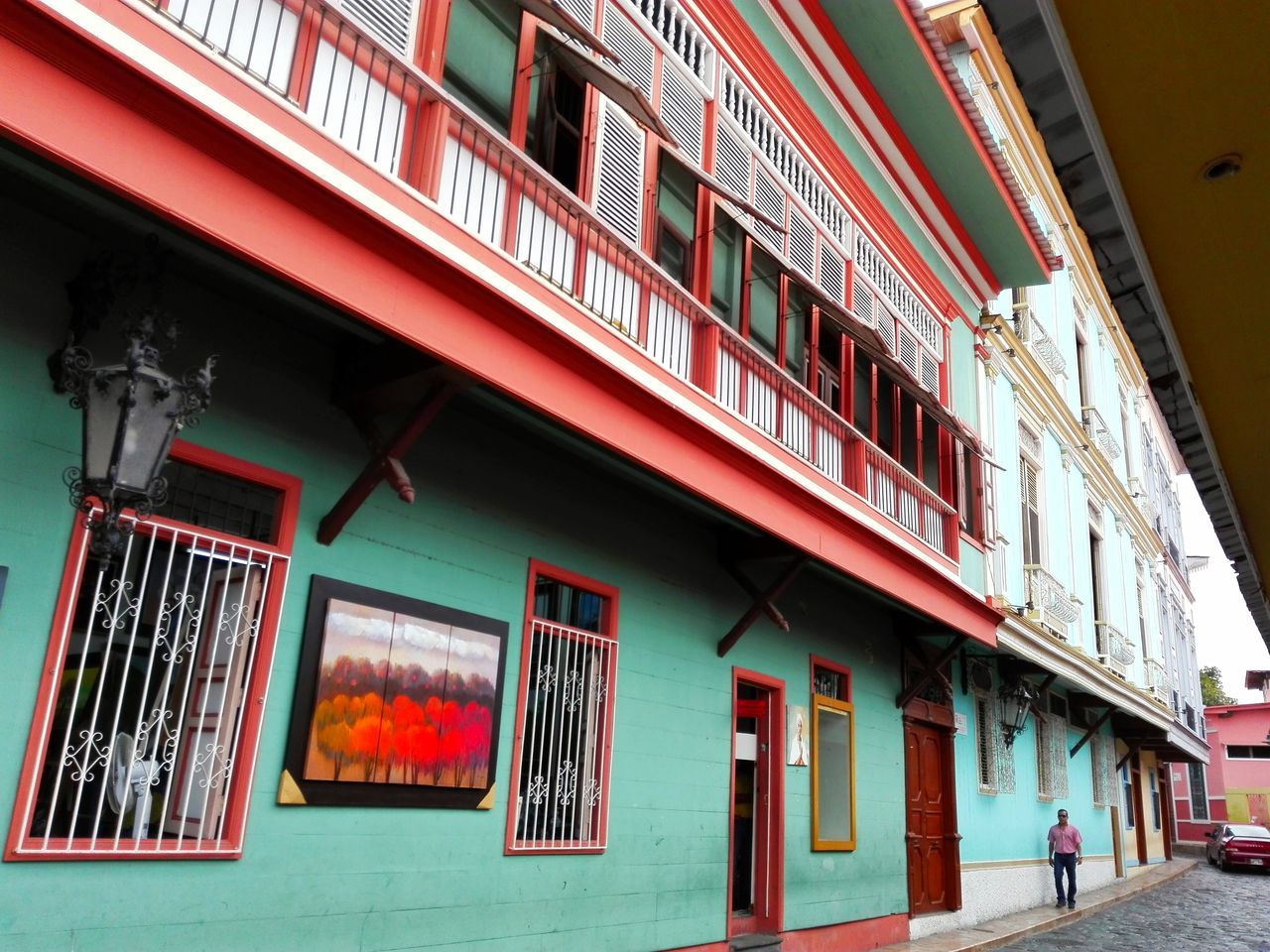 architecture, built structure, building exterior, low angle view, window, text, facade, building, residential building, non-western script, multi colored, city, residential structure, outdoors, day, entrance, exterior, western script, balcony, architectural column