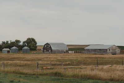 Barn on field against sky