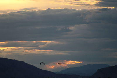 Low angle view of silhouette mountain against sky during sunset