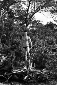 Full length of woman standing in forest