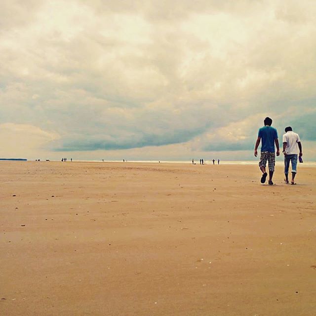 beach, sand, sky, sea, cloud - sky, lifestyles, shore, water, leisure activity, men, horizon over water, cloudy, scenics, person, vacations, walking, tranquil scene, tourist, tranquility