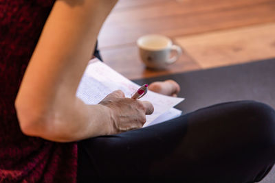 High angle view of woman holding coffee cup