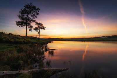 Scenic view of lake at sunset