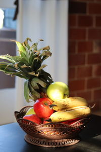 Close-up of apples in basket on table