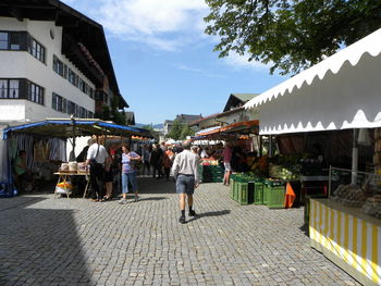 People walking on street amidst buildings in city