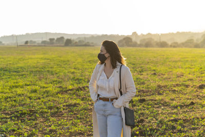 Full length of woman standing on field