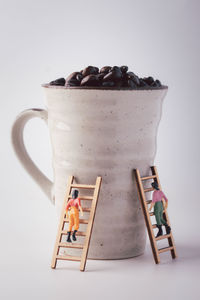 Close-up of chocolate cake on table against white background