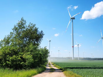 Windmill on field against sky