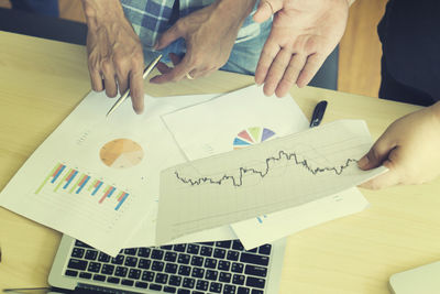 Close-up of businessmen working at office