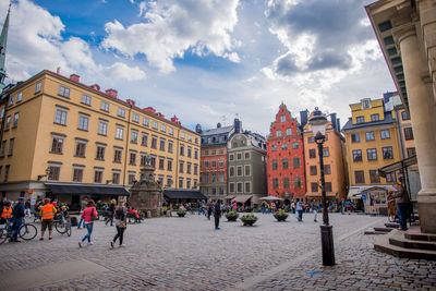 Panoramic view of people on street in city