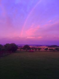 Scenic view of field against sky at sunset