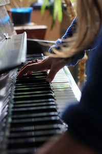 Close-up of hands playing piano