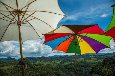 Low angle view of umbrellas against sky