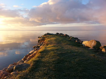 Close-up of sea against sky at sunset