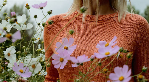 Midsection of woman standing by plants