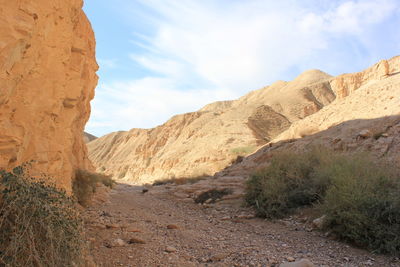 Footpath amidst rocky mountains at wadi og
