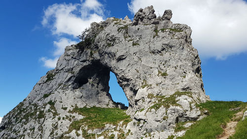 Low angle view of rock formation against sky in italian alps, grigna