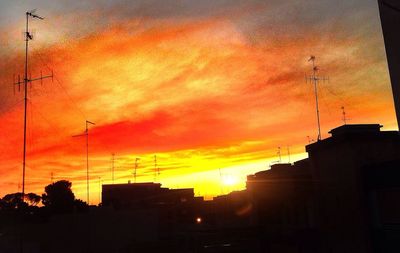 Low angle view of building against sky at sunset