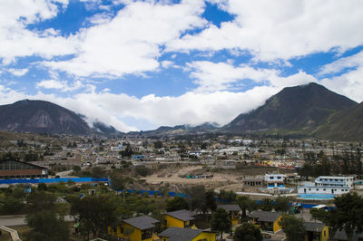 High angle view of cityscape against cloudy sky