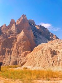 Scenic view of rocky mountains against blue sky