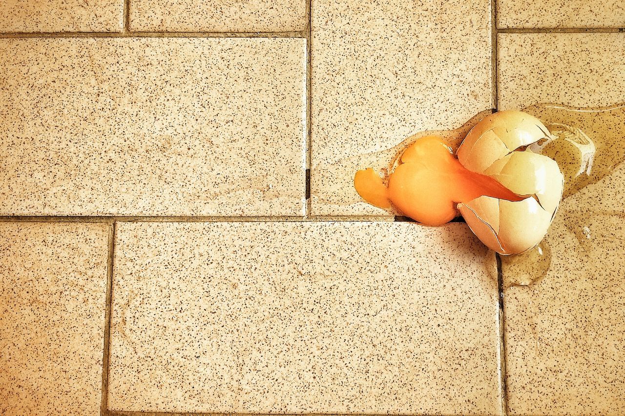 food and drink, food, still life, high angle view, indoors, freshness, orange color, yellow, close-up, healthy eating, vegetable, no people, wall - building feature, day, tiled floor, table, street, directly above, flooring