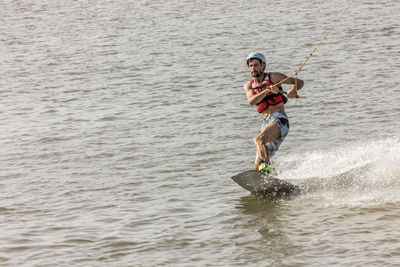 Man kite boarding in river