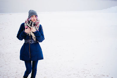 Full length of a girl standing in snow