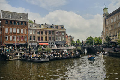 Boats in canal against buildings in city