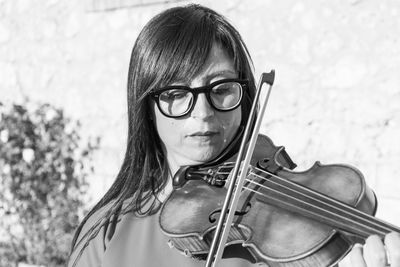 Close-up of woman playing violin outdoors