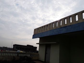 Low angle view of building against cloudy sky