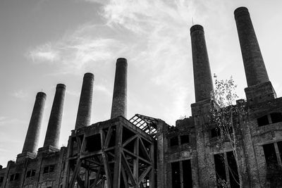 Low angle view of abandoned factory against sky