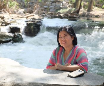 Portrait of woman sitting in water