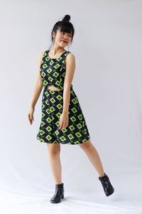Full length portrait of woman standing against white background