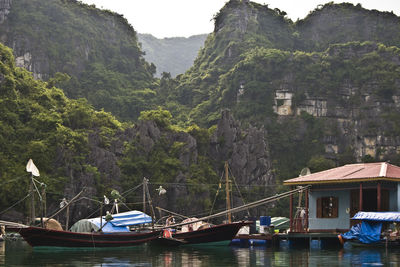 Boats in river with mountains in background
