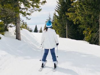 Rear view of man standing on snow covered land