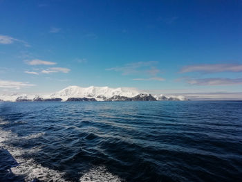 Scenic view of sea against blue sky