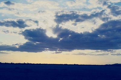 Scenic view of landscape against cloudy sky