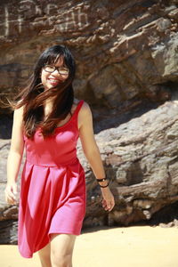 Full length of a young woman standing outdoors