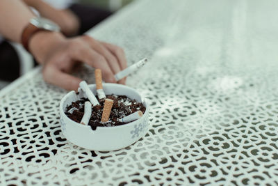 Man holding cigarette on table