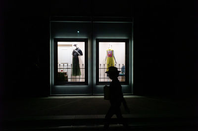 Man and woman walking in front of building