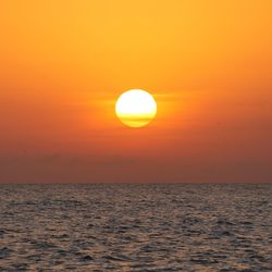 Scenic view of sea against romantic sky at sunset