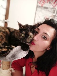 Portrait of woman with cat at home